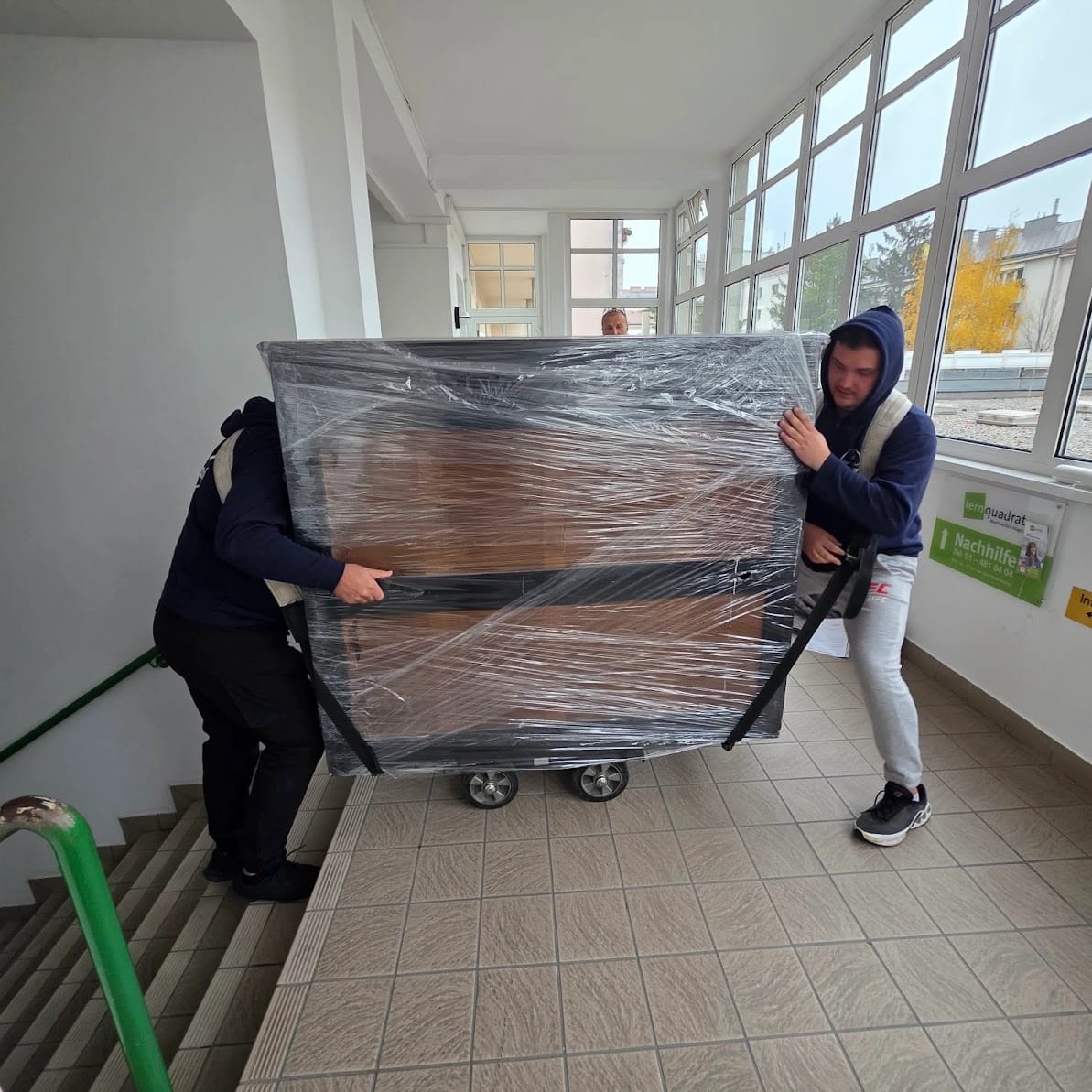A packed piano is moved on the trolley at the pickup address