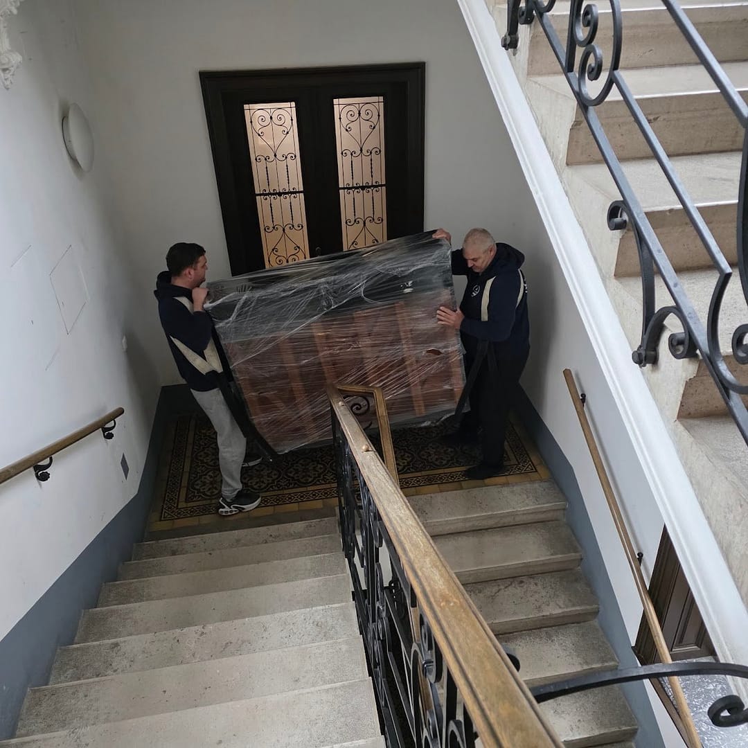 Klavier wird im Stiegenhaus getragen