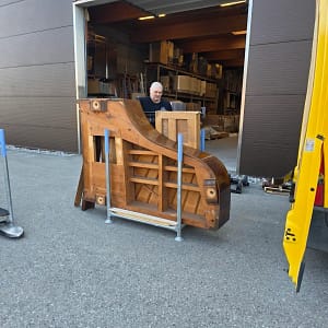 A piano being loaded for disposal