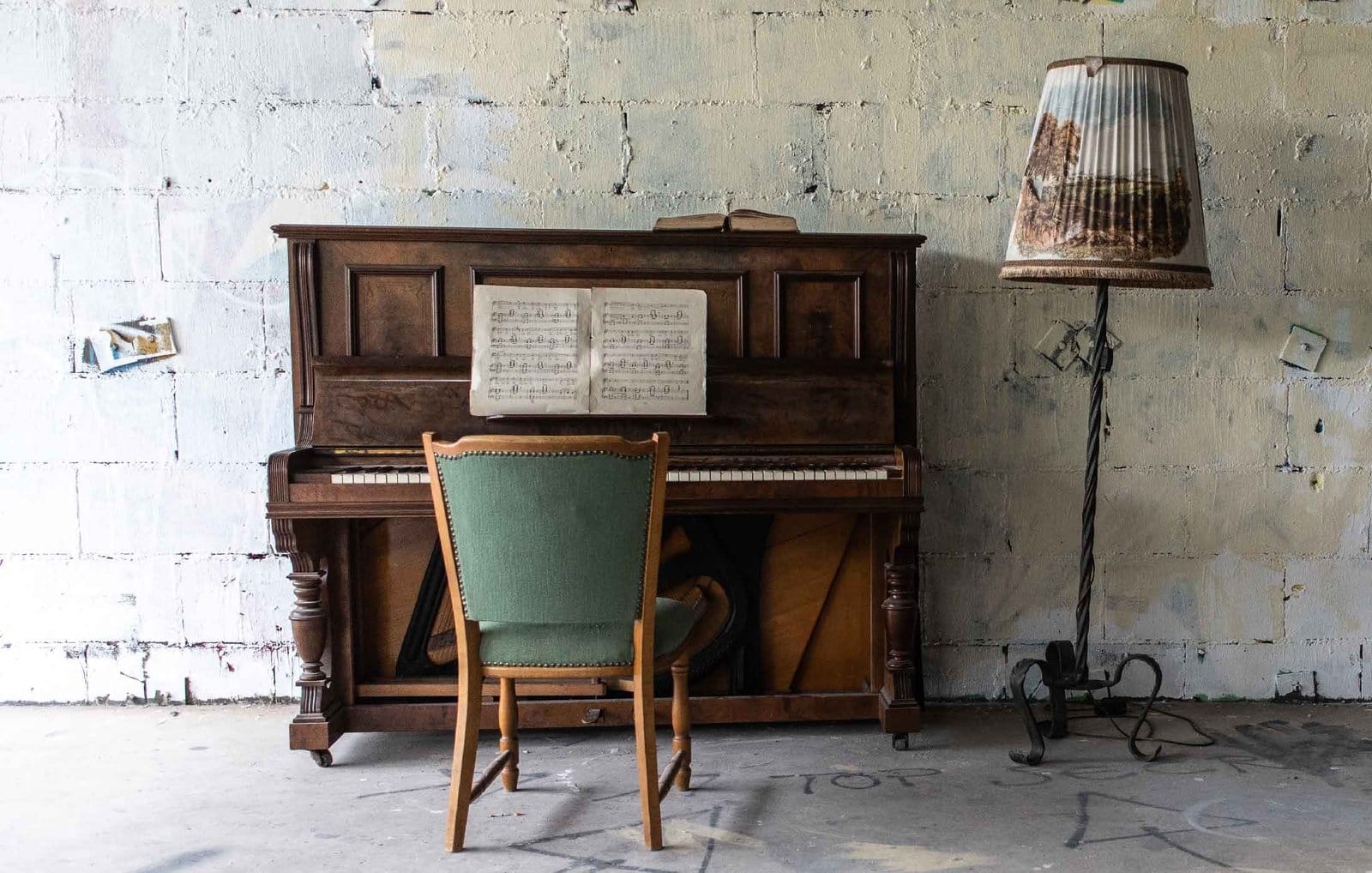 Old upright piano against a white wall